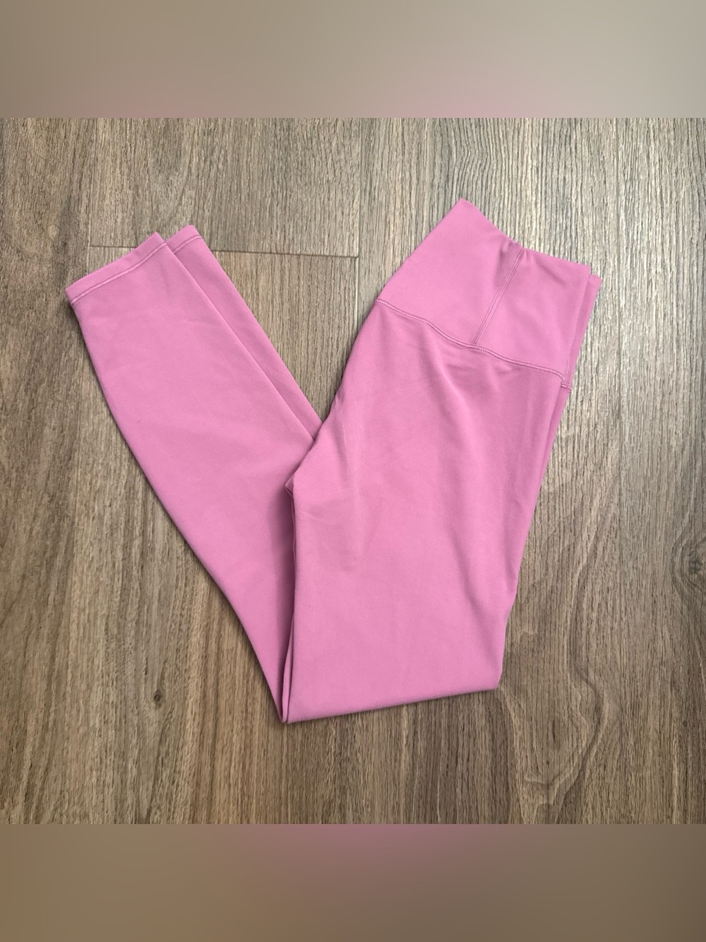 VUORI Pink high-waisted leggings with stretchy fabric.